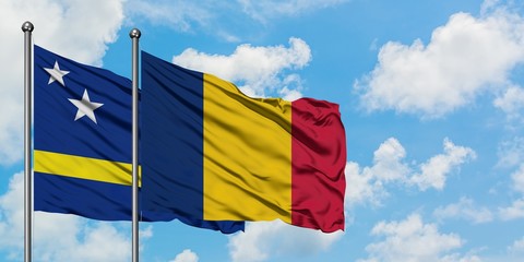 Curacao and Chad flag waving in the wind against white cloudy blue sky together. Diplomacy concept, international relations.