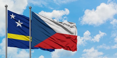 Curacao and Czech Republic flag waving in the wind against white cloudy blue sky together. Diplomacy concept, international relations.