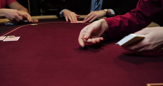 Poker dealer shuffling full deck of playing cards
