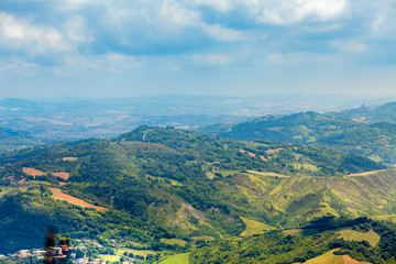 areal view to hills, green woods and houses in European village from mountain Monte Titano, San-Marino