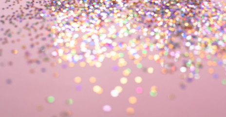Bokeh background of abstract glitter lights. Pink gold and white. Defocused image