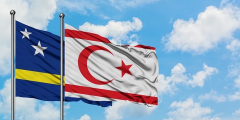 Curacao and Northern Cyprus flag waving in the wind against white cloudy blue sky together. Diplomacy concept, international relations.