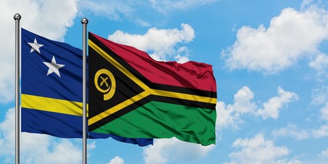 Curacao and Vanuatu flag waving in the wind against white cloudy blue sky together. Diplomacy concept, international relations.