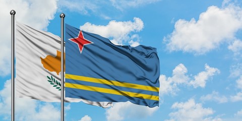 Cyprus and Aruba flag waving in the wind against white cloudy blue sky together. Diplomacy concept, international relations.
