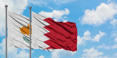 Cyprus and Bahrain flag waving in the wind against white cloudy blue sky together. Diplomacy concept, international relations.