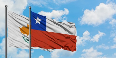 Cyprus and Chile flag waving in the wind against white cloudy blue sky together. Diplomacy concept, international relations.