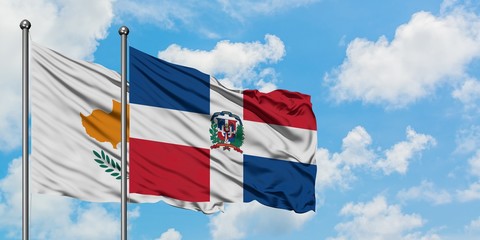 Cyprus and Dominican Republic flag waving in the wind against white cloudy blue sky together. Diplomacy concept, international relations.