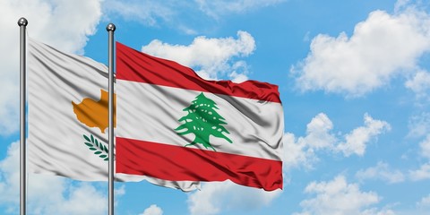 Cyprus and Lebanon flag waving in the wind against white cloudy blue sky together. Diplomacy concept, international relations.
