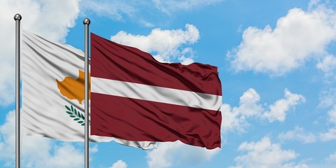 Cyprus and Latvia flag waving in the wind against white cloudy blue sky together. Diplomacy...