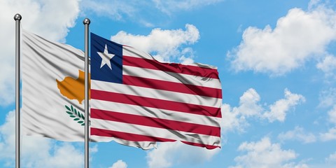 Cyprus and Liberia flag waving in the wind against white cloudy blue sky together. Diplomacy concept, international relations.