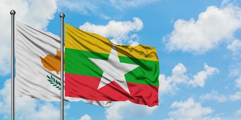 Cyprus and Myanmar flag waving in the wind against white cloudy blue sky together. Diplomacy concept, international relations.