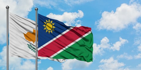 Cyprus and Namibia flag waving in the wind against white cloudy blue sky together. Diplomacy concept, international relations.