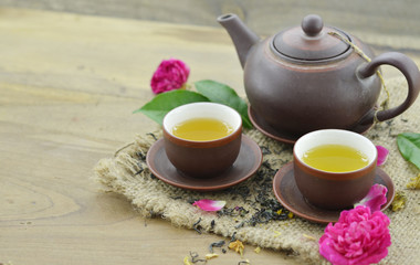 Tea cup and teapot on wooden background