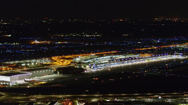 Detroit Michigan Aerial v165 Short nighttime look at airport cityscape, Delta terminal - October 2017