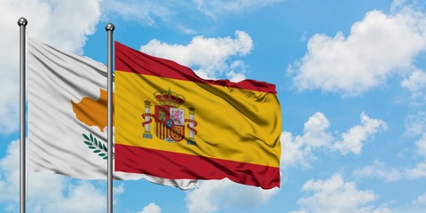 Cyprus and Spain flag waving in the wind against white cloudy blue sky together. Diplomacy concept, international relations.