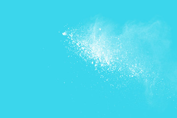 Explosion of colored powder isolated on blue background. Abstract colored background. holi festival.