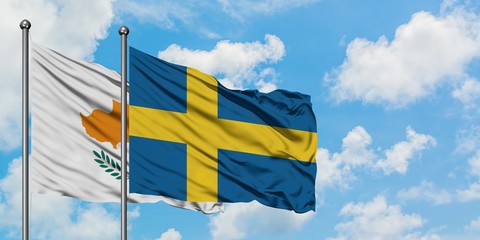 Cyprus and Sweden flag waving in the wind against white cloudy blue sky together. Diplomacy concept, international relations.