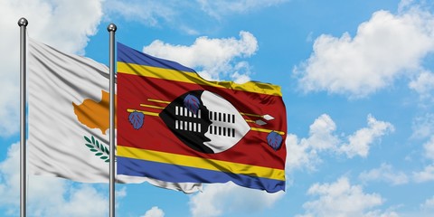 Cyprus and Swaziland flag waving in the wind against white cloudy blue sky together. Diplomacy concept, international relations.