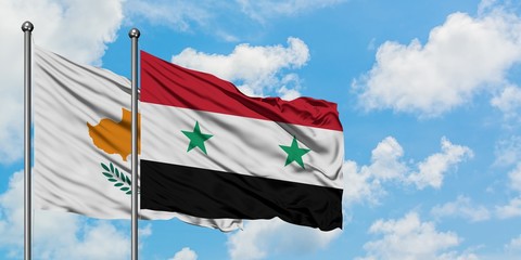 Cyprus and Syria flag waving in the wind against white cloudy blue sky together. Diplomacy concept, international relations.