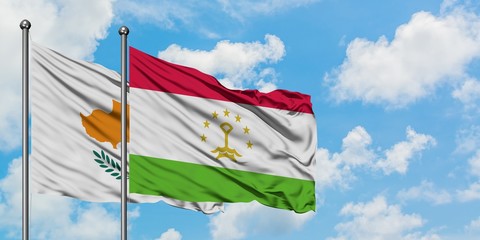 Cyprus and Tajikistan flag waving in the wind against white cloudy blue sky together. Diplomacy concept, international relations.