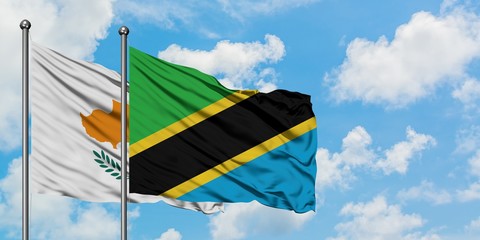 Cyprus and Tanzania flag waving in the wind against white cloudy blue sky together. Diplomacy concept, international relations.