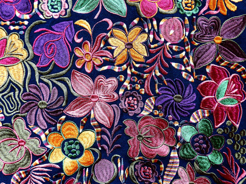 Close up of сolorful embroidered decorative textile and  pillows at the artisan's market in Otavalo, Ecuador