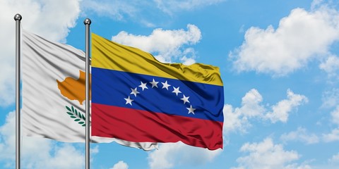 Cyprus and Venezuela flag waving in the wind against white cloudy blue sky together. Diplomacy concept, international relations.