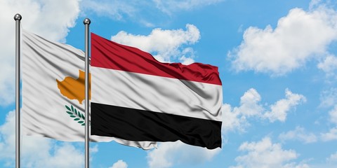 Cyprus and Yemen flag waving in the wind against white cloudy blue sky together. Diplomacy concept, international relations.