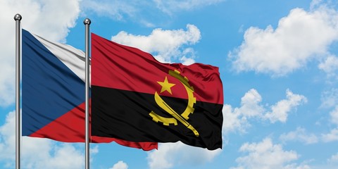 Czech Republic and Angola flag waving in the wind against white cloudy blue sky together. Diplomacy concept, international relations.