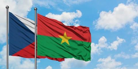 Czech Republic and Burkina Faso flag waving in the wind against white cloudy blue sky together. Diplomacy concept, international relations.