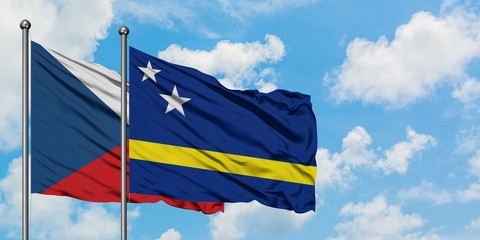 Czech Republic and Curacao flag waving in the wind against white cloudy blue sky together. Diplomacy concept, international relations.