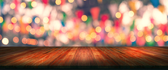 top desk with blur restaurant background,long wooden table and blurred bokeh of night street...