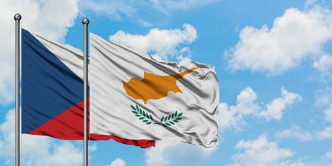 Czech Republic and Cyprus flag waving in the wind against white cloudy blue sky together. Diplomacy concept, international relations.
