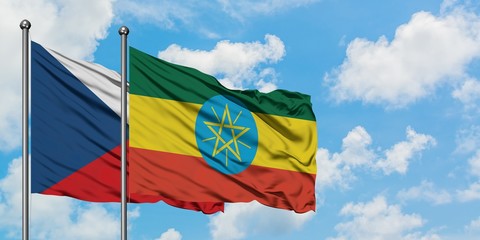 Czech Republic and Ethiopia flag waving in the wind against white cloudy blue sky together. Diplomacy concept, international relations.