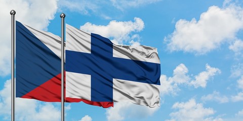 Czech Republic and Finland flag waving in the wind against white cloudy blue sky together. Diplomacy concept, international relations.