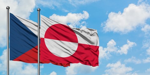 Czech Republic and Greenland flag waving in the wind against white cloudy blue sky together. Diplomacy concept, international relations.