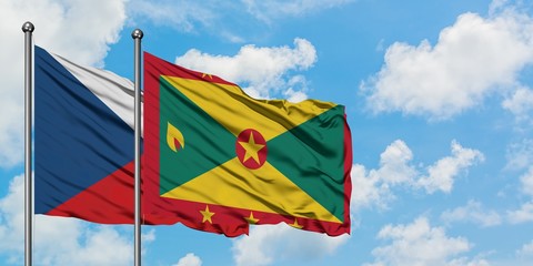 Czech Republic and Grenada flag waving in the wind against white cloudy blue sky together. Diplomacy concept, international relations.