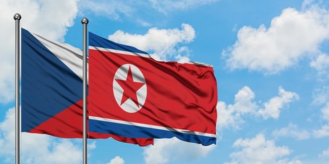 Czech Republic and North Korea flag waving in the wind against white cloudy blue sky together. Diplomacy concept, international relations.
