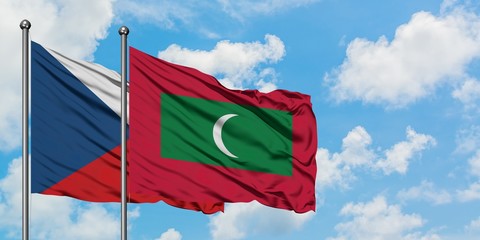 Czech Republic and Maldives flag waving in the wind against white cloudy blue sky together. Diplomacy concept, international relations.