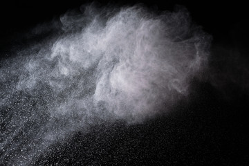 abstract white dust explosion on a black background. 