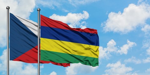 Czech Republic and Mauritius flag waving in the wind against white cloudy blue sky together. Diplomacy concept, international relations.