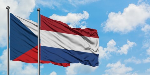 Czech Republic and Netherlands flag waving in the wind against white cloudy blue sky together. Diplomacy concept, international relations.
