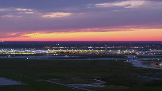 Detroit Michigan Aerial v170 Panning sunset view of airport terminal and runway with plane taxiing - October 2017