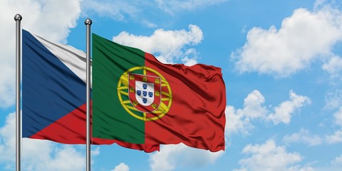 Czech Republic and Portugal flag waving in the wind against white cloudy blue sky together. Diplomacy concept, international relations.