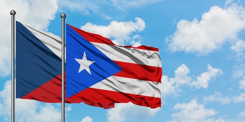 Czech Republic and Puerto Rico flag waving in the wind against white cloudy blue sky together. Diplomacy concept, international relations.
