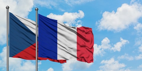 Czech Republic and Reunion flag waving in the wind against white cloudy blue sky together. Diplomacy concept, international relations.