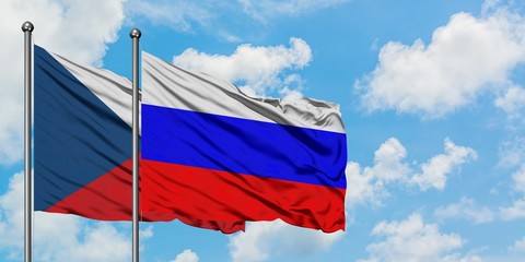 Czech Republic and Russia flag waving in the wind against white cloudy blue sky together. Diplomacy concept, international relations.