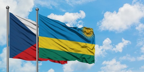 Czech Republic and Rwanda flag waving in the wind against white cloudy blue sky together. Diplomacy concept, international relations.