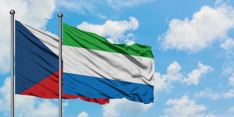Czech Republic and Sierra Leone flag waving in the wind against white cloudy blue sky together. Diplomacy concept, international relations.