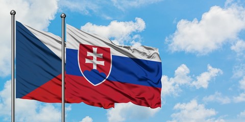 Czech Republic and Slovakia flag waving in the wind against white cloudy blue sky together. Diplomacy concept, international relations.